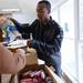 Bryant Community Center volunteer Artis Clark assist a client as he loads their meat selection into a bag on Wednesday, April 24, 2013. After 20 years of operations, the city is looking to expand the Bryant Community Center at 3 W. Eden Court by building a connector to a house the city owns next door. 
Melanie Maxwell I AnnArbor.com